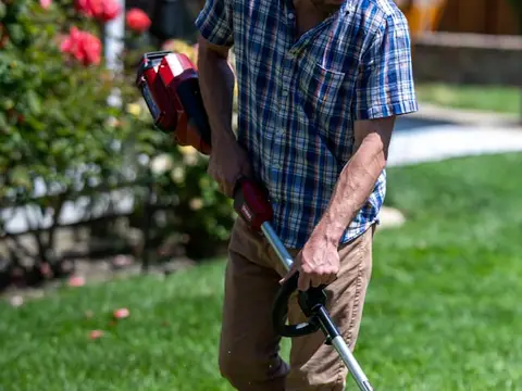 Landscaper trimming a lawn